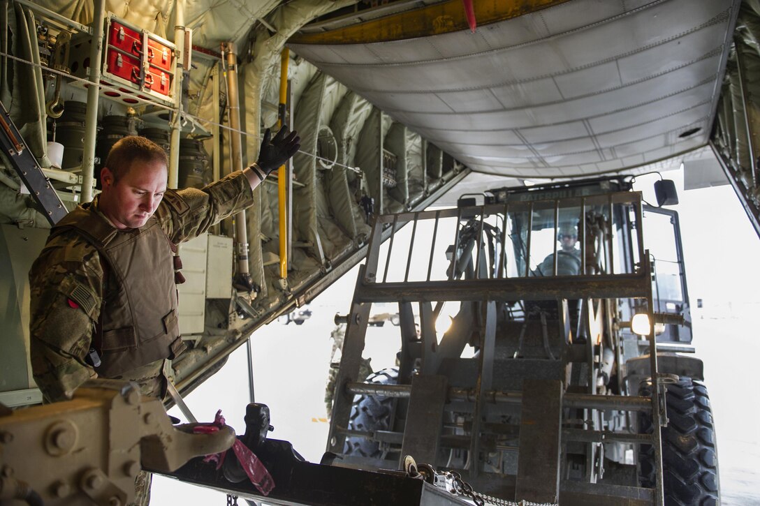 U.S. Air Force Staff Sgt. Michael Demik uses hand signals to guide a forklift to move cargo from a C-130J Super Hercules aircraft at Camp Bastion, Afghanistan, Jan. 3, 2016. Demik is a loadmaster assigned to the 774th Expeditionary Airlift Squadron, deployed from Dyess Air Force Base, Texas. U.S. Air Force photo by Tech. Sgt. Robert Cloys 
