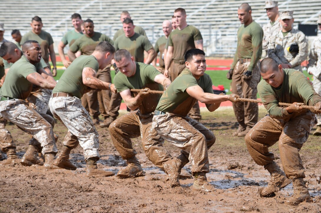 Teams of 10 went head-to-head in a tug-of-war competition in a giant mud pit adjacent to Butler Stadium during the Navy and Marine Corps Relief Society field meet in March.  The event benefited the Relief Society, which supports sailors and Marines experiencing financial difficulties due to deployments, family emergencies and other hardships associated with military life.