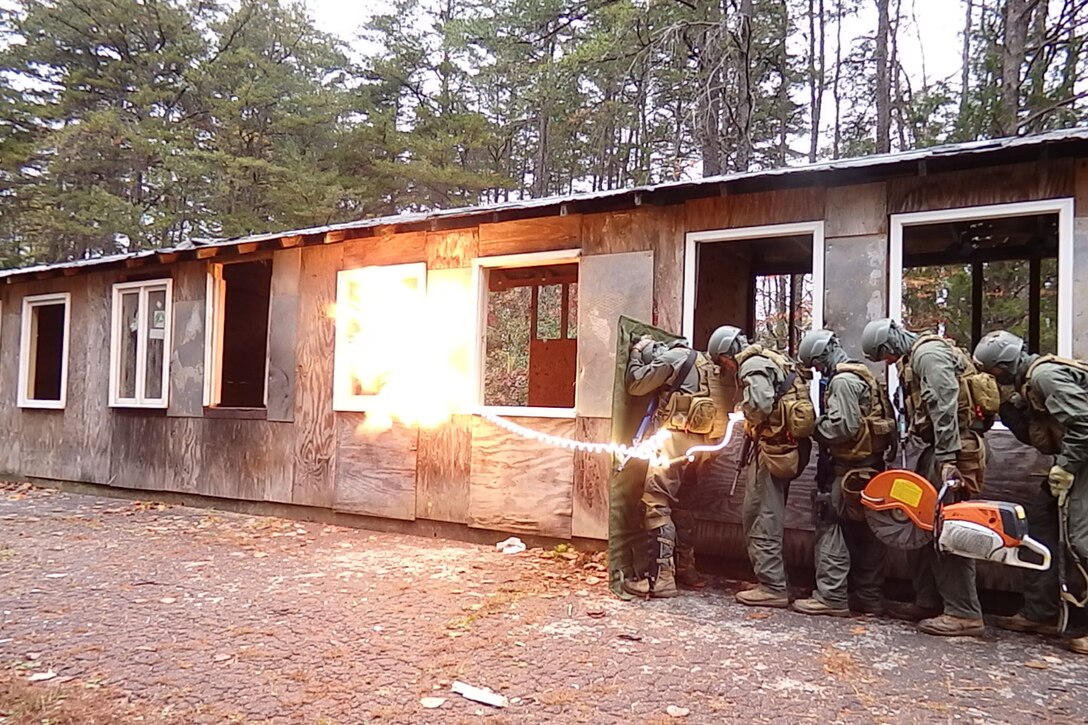 Marine students at the Methods of Entry School brace as explosives go off to breach a door during a test exercise at the Goettge Demolition Range in this undated photo. (photo courtesy  of MOES)