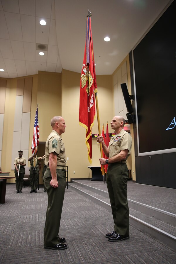 Brigadier General Kevin M. Iiams took the command battle colors from Sgt. Maj. James N. Calbough, sergeant major for U.S. Marine Corps Forces, South, as he assumed the role of commander Jan. 7, 2016.  The Marines from MARFORSOUTH hosted the senior leadership of U.S. Southern Command and other service members during an Assumption of Command ceremony. (Official Marine Corps Photo by SSgt. Earnest J. Barnes/Released)