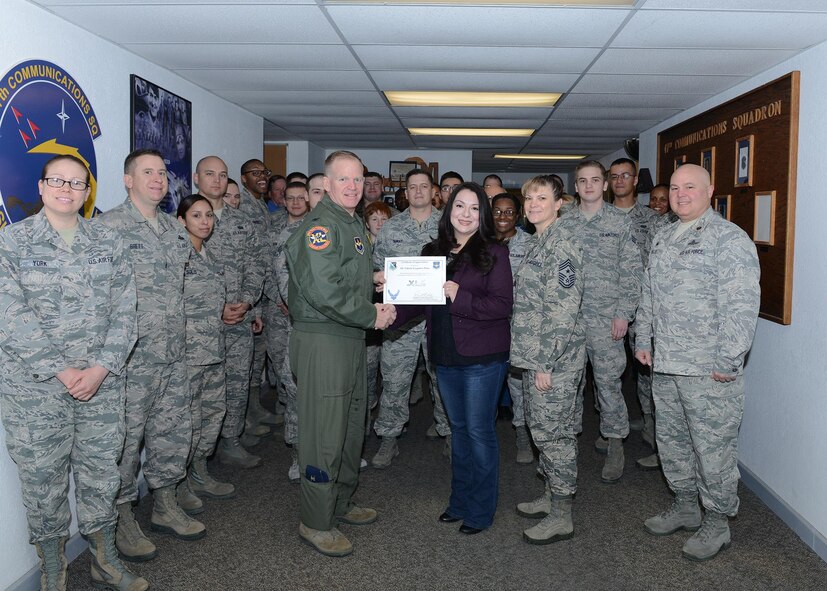 Valerie Plata, center, 47th Communications Squadron unit program coordinator, poses with Col. Darrell Judy, left, 47th Flying Training Wing vice commander, and Chief Master Sgt. Teresa Clapper, 47th FTW command chief, after accepting the “XLer of the Week” award, here, Jan. 6, 2015. The XLer is a weekly award chosen by wing leadership and is presented to those who consistently make outstanding contributions to their unit and Laughlin. (U.S. Air Force photo by Senior Airman Jimmie D. Pike)