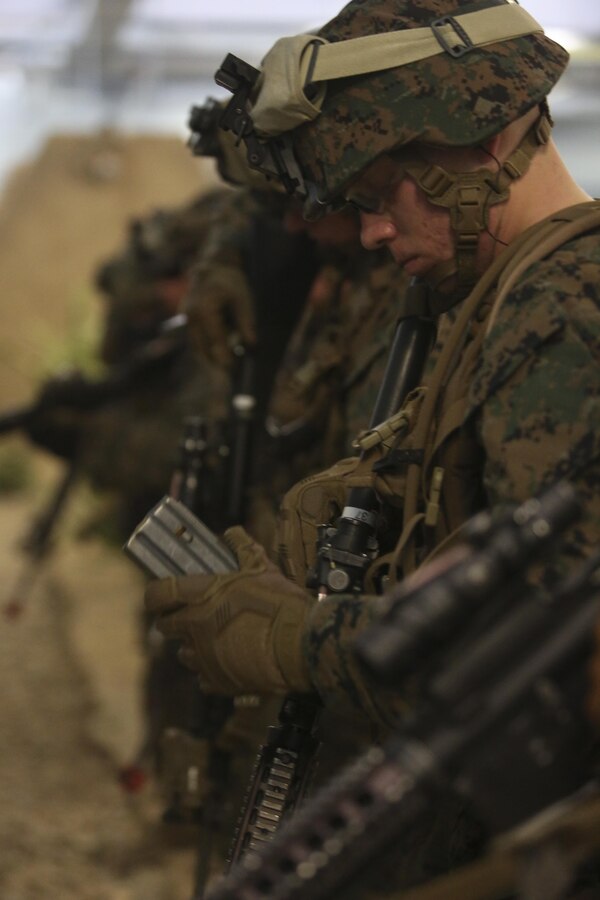 U.S. Marines assigned to Alpha Company, Battalion Landing Team, 1st Battalion, 6th Marine Regiment (BLT 1/6), 22nd Marine Expeditionary Unit, unload their weapons after participating in an infantry immersion training exercise at Camp Lejeune, N.C., Dec. 14, 2015. The Infantry Immersion Trainer provides a training facility for practical application of tactical skills and decision making in an immersive, scenario-based training environment. (U.S. Marine Corps photo by Lance Cpl. Koby I. Saunders/Released)