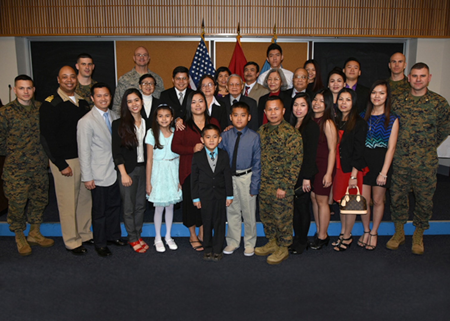 Marine Corps Master Gunnery Sgt. Phu Cao,(front row, center)  poses with his extended family and fellow servicemen during his promotion ceremony Jan. 5 in the McKeever Auditorium on Defense Supply Center Richmond, Virginia.  (Photo by Jackie Roberts, DLA Installation Support at Richmond)