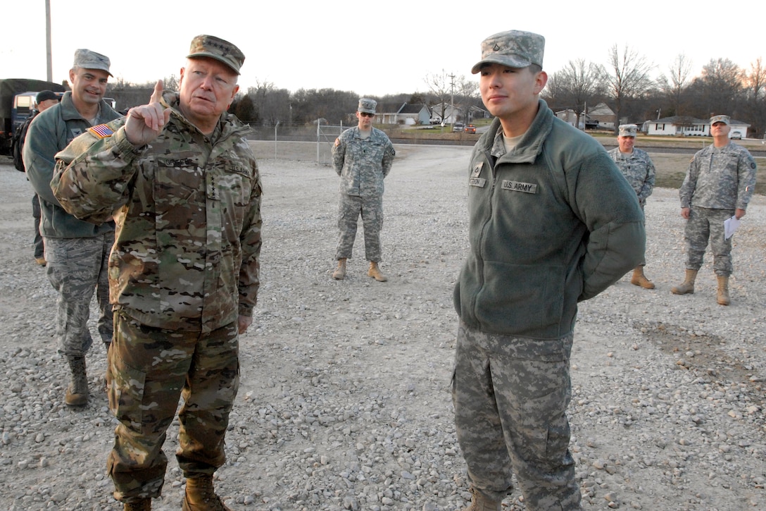 Army Pfc. Allen Pattison, right, explains the capabilities of the Army's 2,000-gallon Hippo system to Army Gen. Frank Grass, chief of the National Guard Bureau in Pacific, Mo. Jan. 5, 2016. Pattison is a water treatment specialist assigned to the Missouri National Guard’s Company A, 311th Brigade Support Battalion. The Hippos are used to transport and store potable water to meet drinking and hygiene needs in field conditions. Missouri Army National Guard photo by Staff Sgt. Christopher Robertson