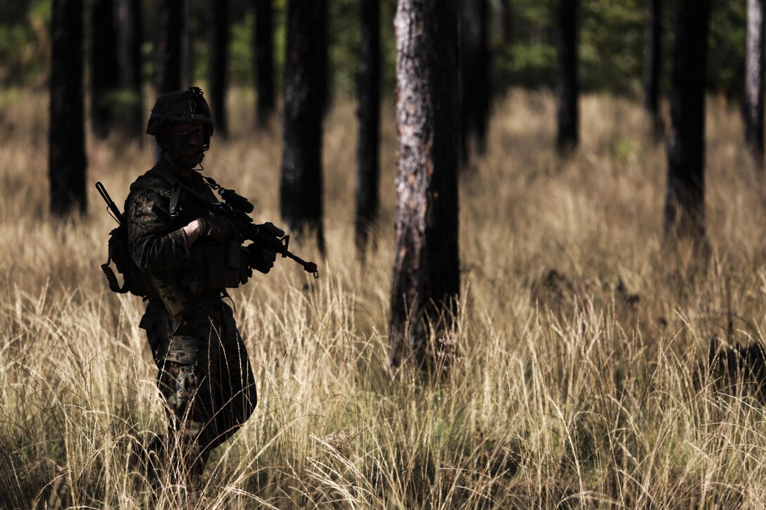 U.S. Marine Corps Cpl. John Tiers, squad leader, Battalion Landing Team, 1st Battalion, 6th Marine Regiment (BLT 1/6), 22nd Marine Expeditionary Unit,  patrols through the woods of Camp Lejeune, N.C., Dec. 16, 2015. The exercise allowed the Marines to practice setting up patrol bases and enhances basic infantry principles. (Official Marine Corps photo by Cpl. Ryan G. Coleman/released)