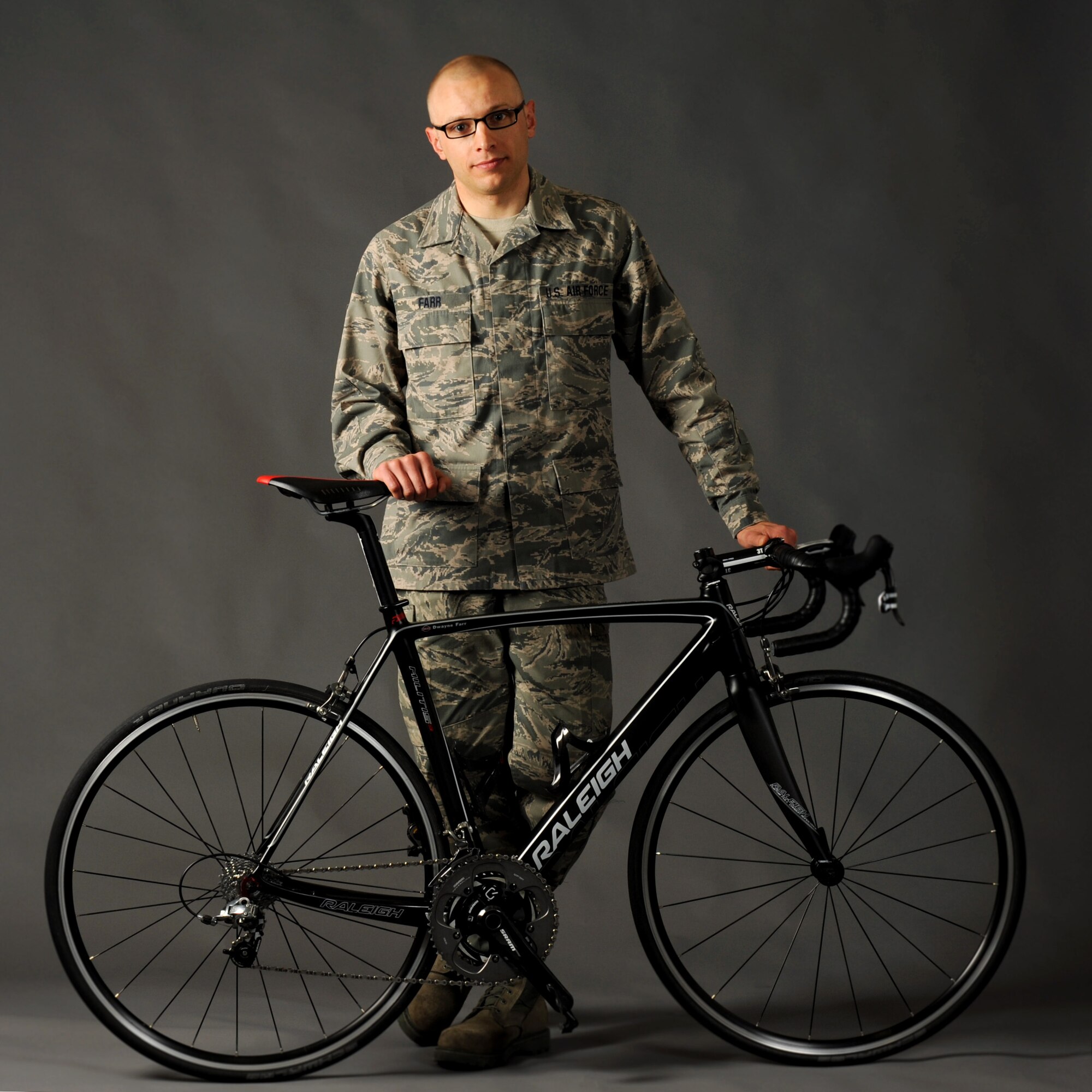 Tech. Sgt. Dwayne Farr, assigned to the Oregon Air National Guard’s 142nd Aircraft Maintenance Squadron, poses with one of his bicycles on Portland Air National Guard Base, Ore., April 7, 2013. Farr has been training and racing as an endurance cyclist during the past four years and was part of the Military World Games in Mungyeoung, South Korea, Oct. 6, 2015. (U.S. Air National Guard photo/Tech. Sgt. John Hughel)
