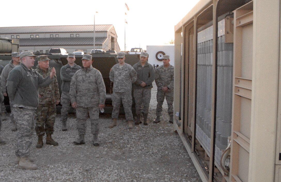 Army Sgt. Russell Pennell, left foreground, discusses operations and capabilities of the Army's tactical water purification system with Army Gen. Frank Grass, chief of the National Guard Bureau in Pacific, Mo. Jan. 5, 2016. Pennell is a team leader assigned to the Missouri National Guard’s Company A, 311th Brigade Support Battalion. Missouri Army National Guard photo by Staff Sgt. Christopher Robertson