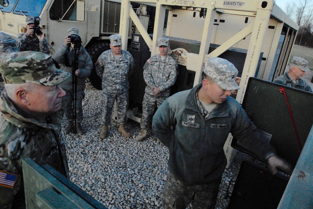 Army Pfc. Allen Pattison, right, briefs Army Gen. Frank Grass, chief of the National Guard Bureau in Pacific, Mo. on the capabilities of the Army's 2,000 gallon hippo system Jan. 5, 2016. Missouri Army National Guard photo by Staff Sgt. Christopher Robertson