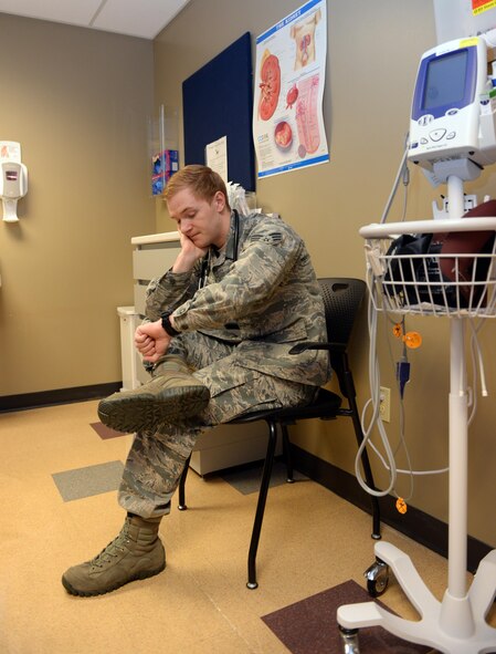 Senior Airman Cameron Springer, 2nd Medical Group family health medical technician, looks at his watch as he waits for a patient to arrive for an appointment at Barksdale Air Force Base, La., Dec. 28, 2015. The 2nd MDG, which averages 398 no-show appointments per month, asks active duty members and dependents to do everything they can to make their scheduled appointments, or notify the clinic more than two hours prior to the appointment, so another patient can be seen. (U.S. Air Force photo/Airman 1st Class Curt Beach)