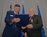 Lt. Gen. Brad Heithold, Air Force Special Operations Command commander, presents a certificate of service to Herb Mason, AFSOC historian, at his retirement ceremony on Hurlburt Field, Fla., Jan. 7, 2016. Mason led the AFSOC history office in completing 25 on-time annual historical reports--a feat unmatched by any other Major Command. (U.S. Air Force photo/Staff Sgt. Melanie Holochwost)