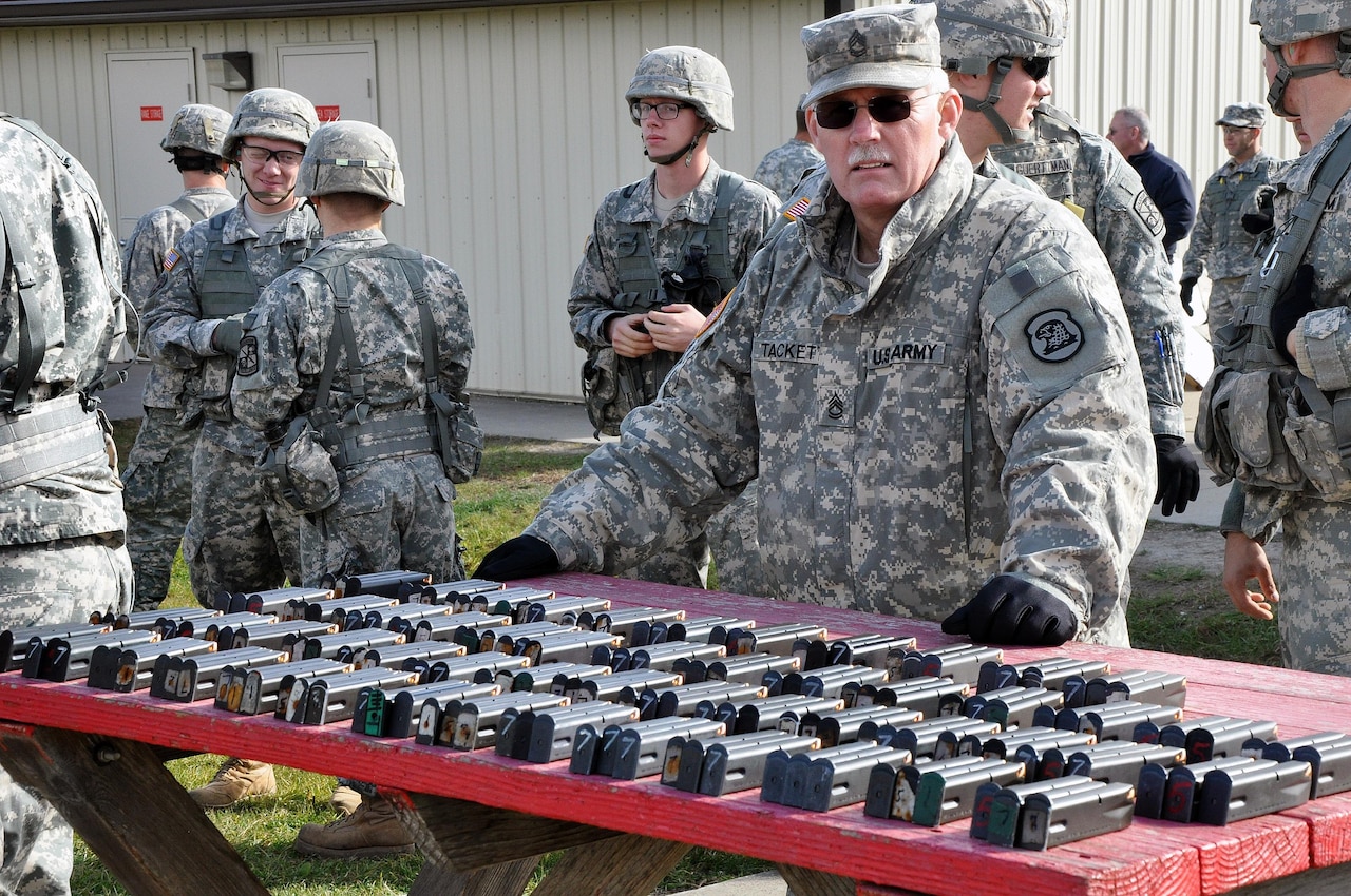 Iowa Army National Guard Sgt. 1st Class Harold G. Tackett, the senior supply sergeant at the Iowa National Guard's Joint Forces Headquarters and a native of Runnells, Iowa, prepares to issue ammunition during a German Armed Forces Badge for Military Proficiency competition at Camp Dodge in Johnston, Iowa, Nov. 8, 2014. Iowa Army National Guard photo by Master Sgt. Duff E. McFadden