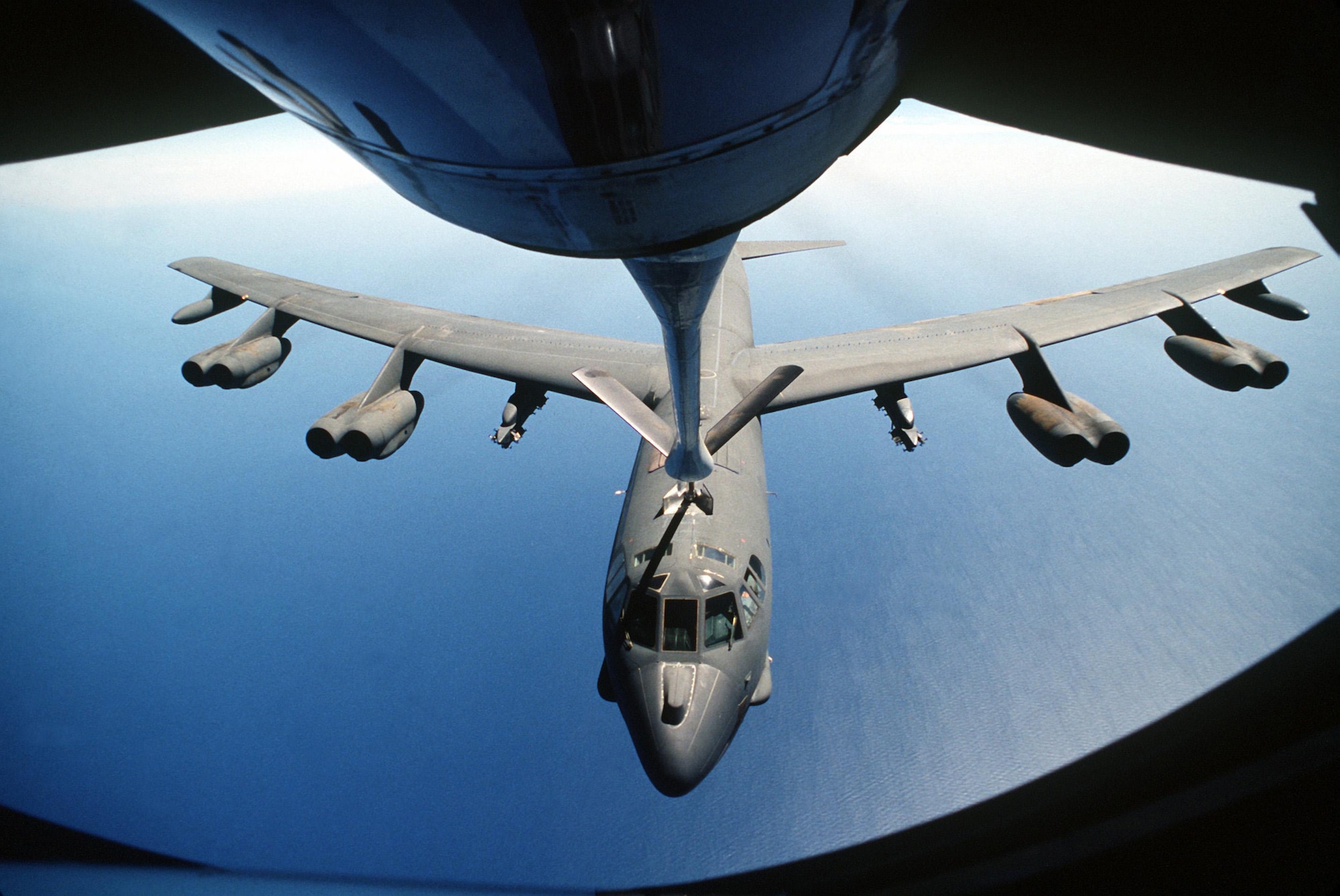 A KC-135 Stratotanker aircraft boom operator refuels a B-52 Stratofortress aircraft, center, during air operations for Operation Desert Storm over Southwest Asia Feb. 1, 1991. (U.S. Air Force photo by Senior Airman Chris Putnam/Released)