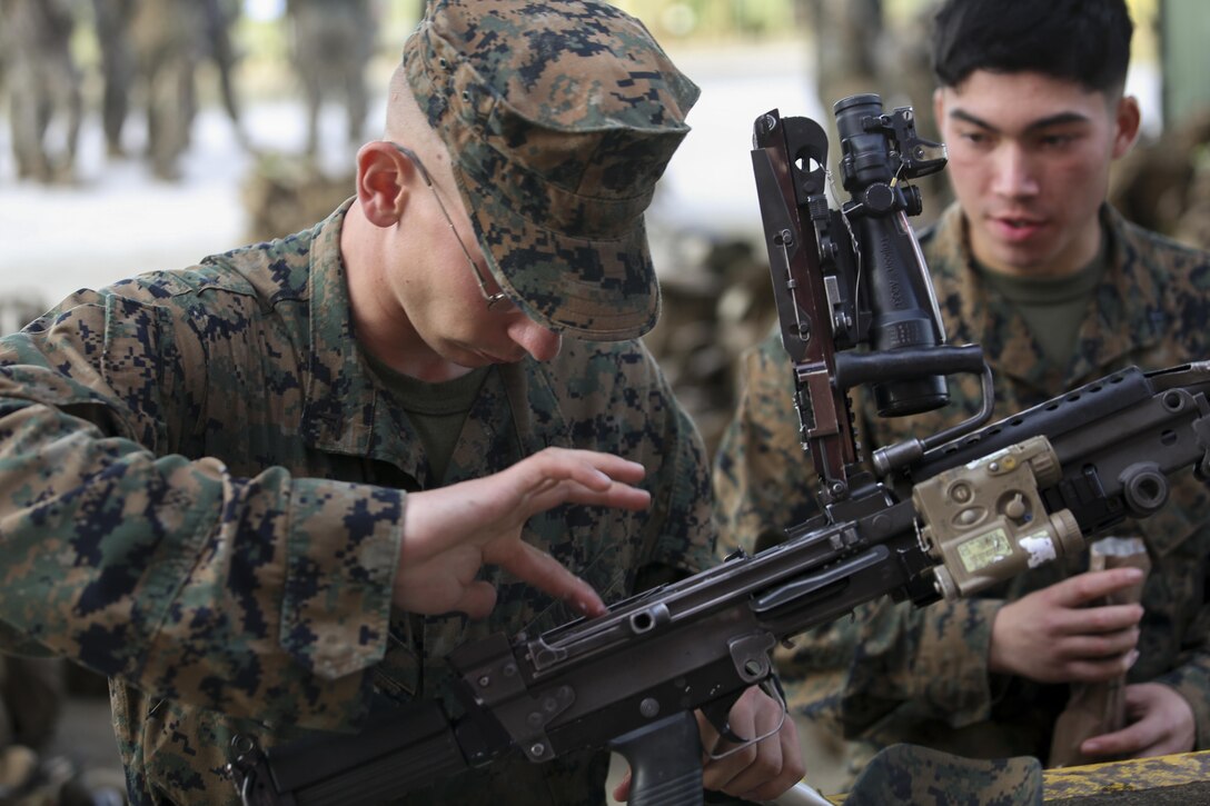 U.S. Marine Corps Lance Cpl. Jesse R. Korpisz, a machine gunner assigned to Alpha Company, Battalion Landing Team, 1st Battalion, 6th Marine Regiment (BLT 1/6), 22nd Marine Expeditionary Unit, cleans an M249 Squad Automatic Weapon before participating in an infantry immersion training exercise at Camp Lejeune, N.C., Dec. 14, 2015. BLT 1/6 conducted the training in preparation for a future deployment with the 22nd Marine Expeditionary Unit. (U.S. Marine Corps photo by Lance Cpl. Koby I. Saunders/ 22 MEU/Released)