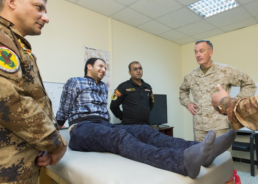 U.S. Marine Corps Gen. Joseph F. Dunford Jr., chairman of the Joint Chiefs of Staff, meets with an Iraqi special operator wounded during a battle, during a visit to an Iraqi wounded warrior clinic in Baghdad, Jan. 7, 2016. DoD photo by Navy Petty Officer 2nd Class Dominique A. Pineiro