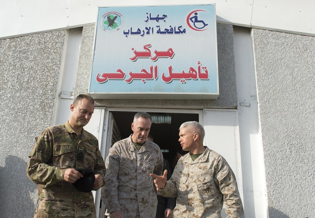 U.S. Marine Corps Gen. Joseph F. Dunford Jr., center, chairman of the Joint Chiefs of Staff, listens to a Marine assigned to Combined Joint Task Force - Operation Inherent Resolve, as he departs an Iraqi wounded warrior clinic in Baghdad, Jan. 7, 2016. DoD photo by Navy Petty Officer 2nd Class Dominique A. Pineiro