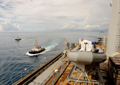DIEGO GARCIA (Jan. 6, 2016) Tugboats come alongside the submarine tender USS Emory S. Land (AS 39) as she approaches Diego Garcia. Emory S. Land is a forward deployed expeditionary submarine tender on an extended deployment conducting coordinated tended moorings and afloat maintenance in the U.S. 5th and 7th Fleet areas of operations. (U.S. Navy photo by Mass Communication Specialist 3rd Class Austin L. Ingram/Released)