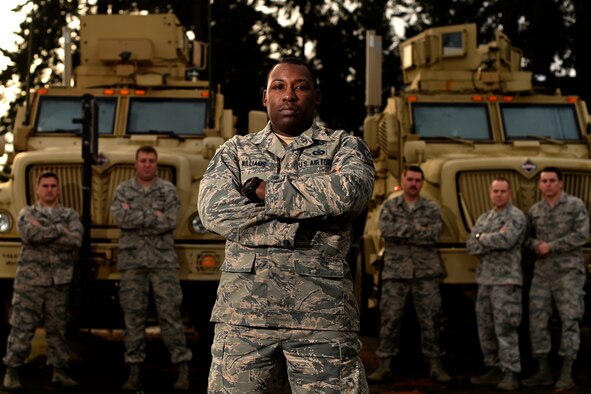 U.S. Air Force Tech. Sgt. LaPaul Williams, a 5th Air Support Operations Squadron fighter duty technician from Joint Base Lewis-McChord, Wash., stands with his friends and fellow Airmen behind him. These are the Airmen who were there for Williams during his treatment and surgeries while battling a rare cancer, dermatofibrosarcoma protuberans. (U.S. Air Force photo by Tech. Sgt. Timothy Chacon/Released)