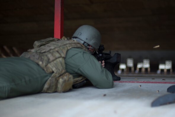 U.S. Air Force Master Sgt. Randy VanHorn, 41st Rescue Squadron flight chief, fires a round into his target, Jan. 6, 2016, at Moody Air Force Base, Ga. Airmen fire from an array of positions including supported and unsupported prone, kneeling and standing. (U.S. Air Force photo by Airman Daniel Snider/Released)