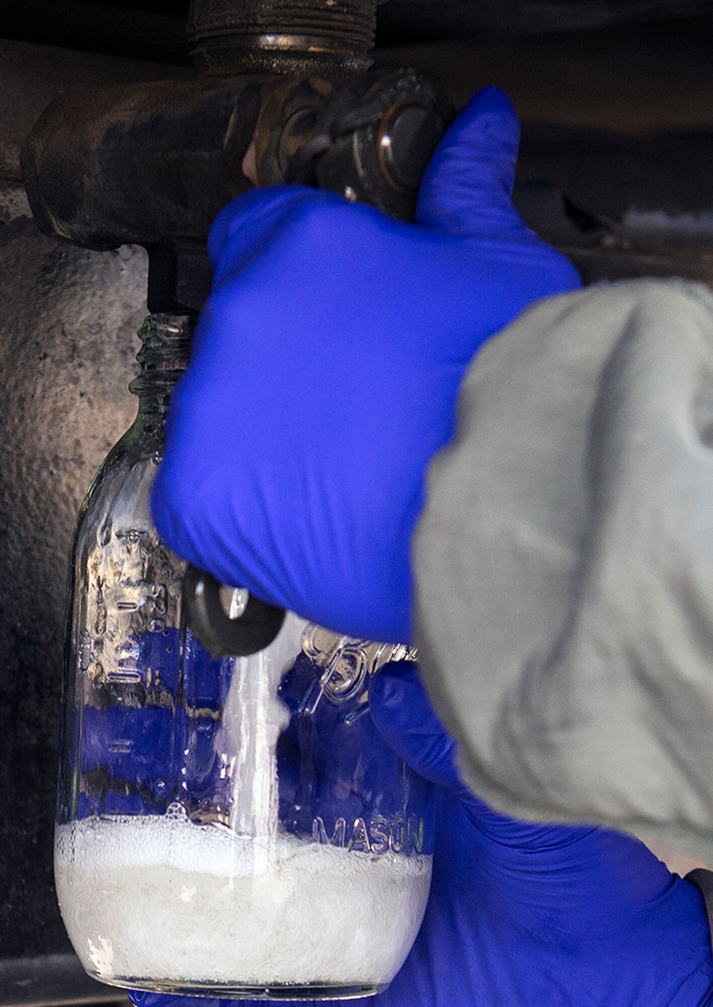 U.S. Air Force Airman Brendan Melms, 23d Logistics Readiness Squadron fuels distribution operator, takes a fuel sample from an R-11 refueling truck during a checkpoint inspection, Jan. 6, 2016, at Moody Air Force Base, Ga. On average, the section handles up to 800,000 gallons of jet fuel per month. (U.S. Air Force photo by Airman 1st Class Greg Nash/Released) 
