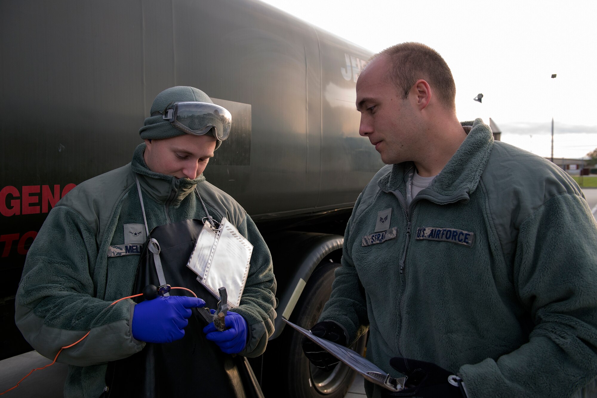 U.S. Air Force Airman Brendan Melms, left, 23d Logistics Readiness Squadron fuels distribution operator, shows Senior Airman Marcus Strait, 23d LRS fuels distribution operator, a discrepancy with a ground clamp during a checkpoint inspection, Jan. 6, 2016, at Moody Air Force Base, Ga. It is a minimum requirement that two personnel conduct the inspection, which can average up to 15 minutes per vehicle depending on any discrepancies discovered.
(U.S. Air Force Airman 1st Class Greg Nash/Released)
