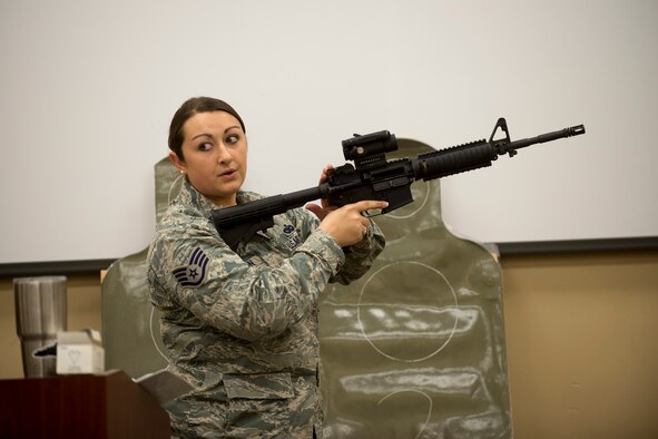 U.S. Air Force Staff Sgt. Michelle Peterson, 23d Security Forces Squadron combat arms training and maintenance instructor, demonstrates how to properly handle the M4 rifle, Jan. 6, 2016, at Moody Air Force Base, Ga. During the course, Airmen learn how to clean and inspect their weapons for defects. (U.S. Air Force photo by Airman Daniel Snider/Released)