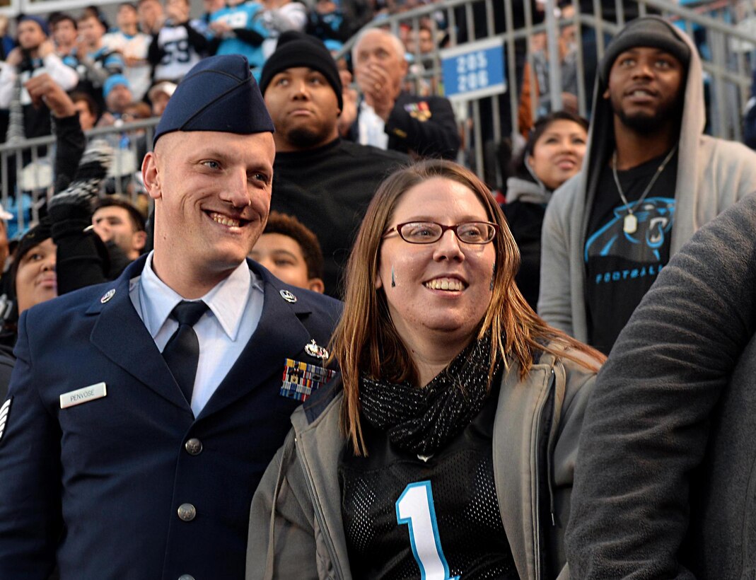 Tech. Sgt. Brandon Penvose, 4th Comptroller Squadron budget analyst, and his wife, Michele Penvose, are recognized for their service during the Panthers vs. Buccaneers game, Jan. 3, 2016, at Bank of America Stadium in Charlotte, North Carolina. Six Team Seymour members were given free tickets to the game in honor of their service. (U.S. Air Force photo/Airman 1st Class Ashley Williamson)