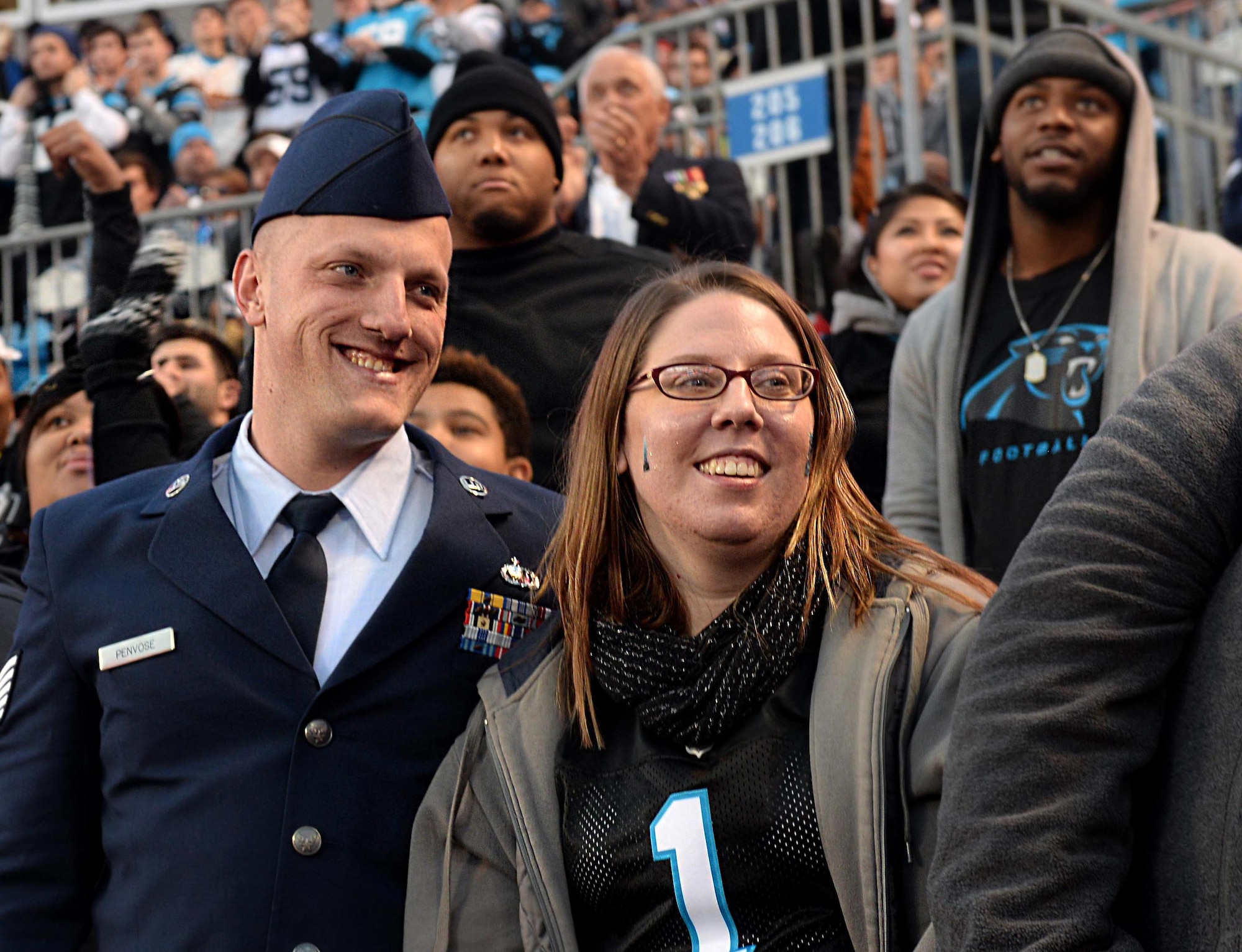Tech. Sgt. Brandon Penvose, 4th Comptroller Squadron budget analyst, and his wife, Michele Penvose, are recognized for their service during the Panthers vs. Buccaneers game, Jan. 3, 2016, at Bank of America Stadium in Charlotte, North Carolina. Six Team Seymour members were given free tickets to the game in honor of their service. (U.S. Air Force photo/Airman 1st Class Ashley Williamson)