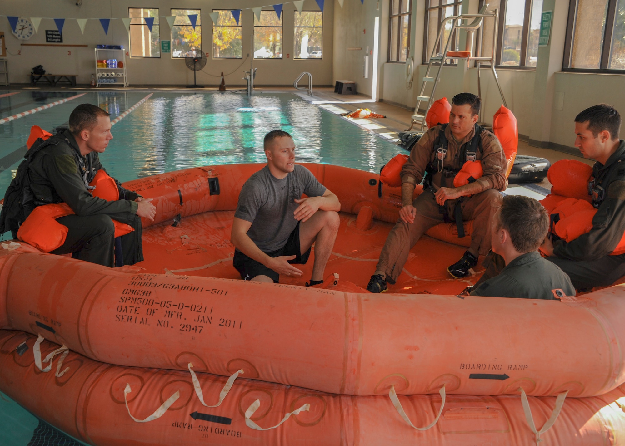 U.S. Air Force Staff Sgt. Seth Reed, 355th Operations Support Squadron Survival, Evasion, Resistance, Escape instructor, educates trainees about setting up an emergency canopy on a 20-person raft during a SERE refresher course at Davis-Monthan Air Force Base, Ariz., Jan. 6, 2016. The canopy can be used to protect from the sun and to collect fresh water in the event of rain. (U.S. Air Force photo by Airmen 1st Class Ashley N. Steffen/Released)  