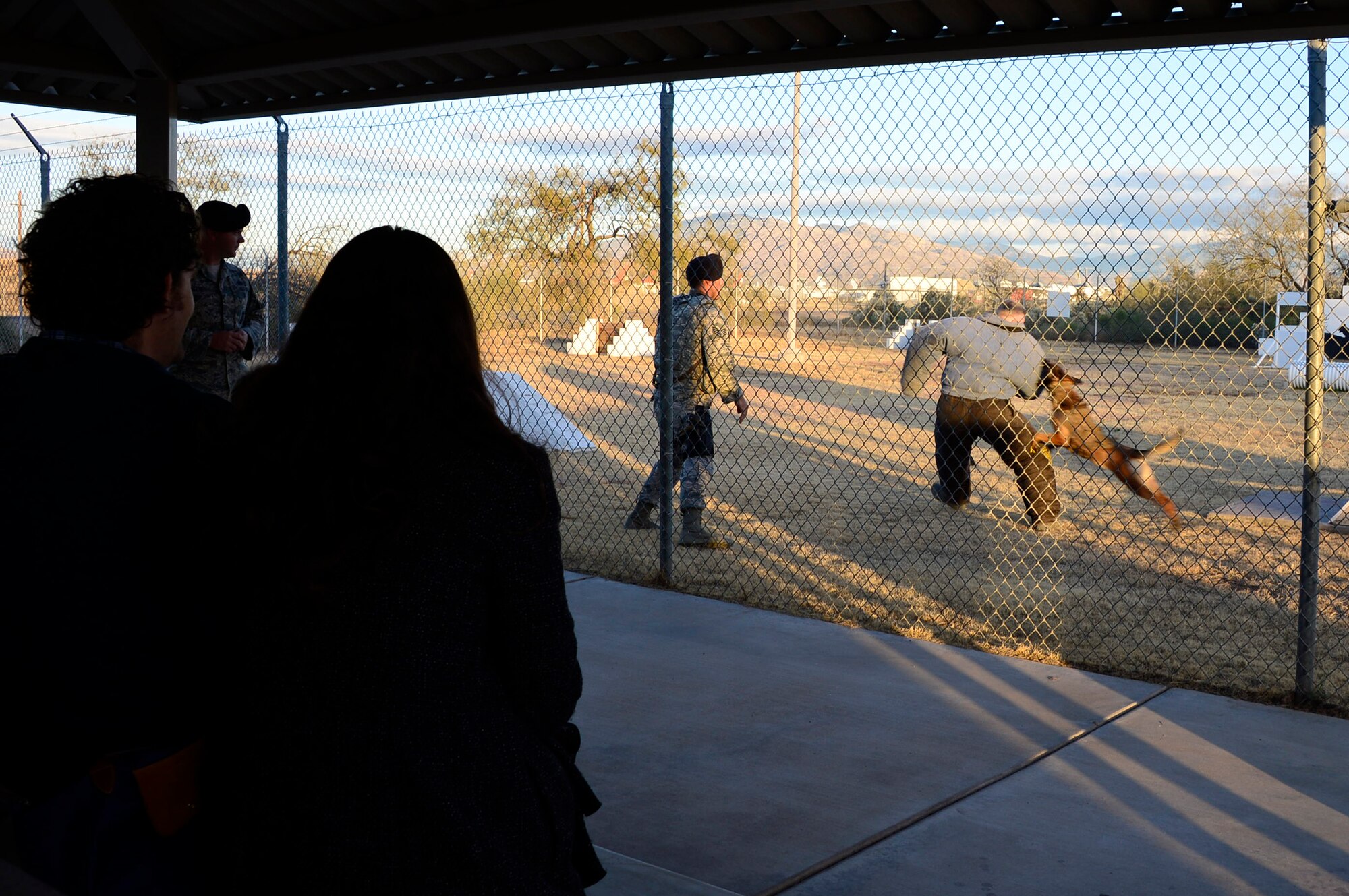 Students from Salpointe High School watch as the 355th Security Forces Squadron K-9 unit gives a demonstration of their working dog and handler capabilities at the kennels on Davis-Monthan AFB, Ariz., Jan. 6, 2016. The Salpointe High School Military Appreciation Club supports military and veteran groups throughout Tucson, Ariz. (U.S. Air Force photo by Tech. Sgt. Heather R. Redman/Released)