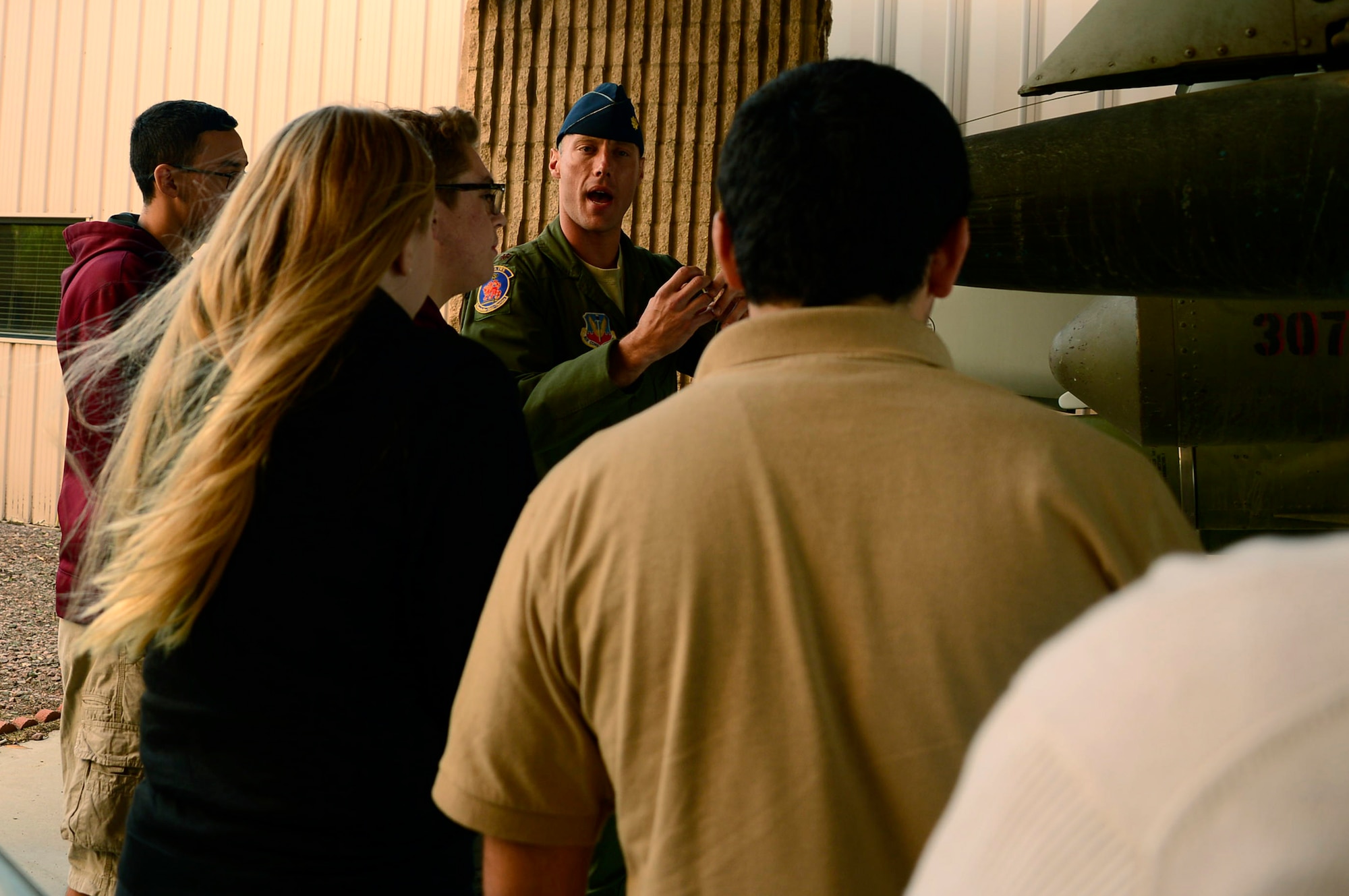 U.S. Air Force Maj. Chris Palmer, 12th Air Force (Air Forces Southern) Aide de Camp, briefs a group of students from Salpointe High School on the weapon capabilities of the A-10 Thunderbolt during a tour of Davis-Monthan AFB, Ariz., Jan. 6, 2016. The Salpointe High School Military Appreciation Club supports military and veteran groups throughout Tucson, Ariz. (U.S. Air Force photo by Tech. Sgt. Heather R. Redman/Released)