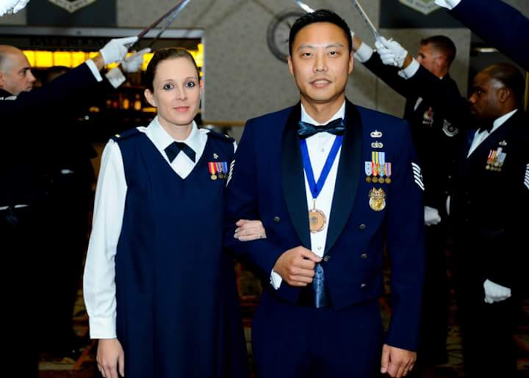 Second Lt. Nadine Suh, 22nd Medical Support Squadron TRICARE Operations and Patient Administration flight commander, and Tech. Sgt. Young Suh, 22nd Contracting Squadron plans and programs section chief, pose for a photo during Young’s Senior NCO Induction Ceremony, Oct. 2, 2015, at McConnell Air Force Base, Kan. Nadine and Young, who met in Austria in 2005, are currently assigned to McConnell AFB through a joint-spouse assignment after Nadine commissioned through the Air Force Commissioned Officer Training Medical Service Corps program in 2014. (U.S. Air Force photo/Senior Airman Victor J. Caputo)