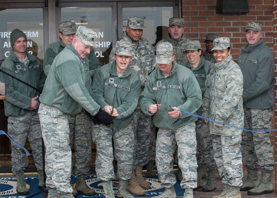 Leadership from across Joint Base Langley-Eustis, Va., cut the ribbon signaling the grand opening of the JBLE Professional Development Center at Langley Air Force Base, Va., Jan. 4, 2016. The newly renovated facility will now bring the various aspects of the base professional development program under one roof to provide a one-stop-shop for JBLE Service members’ career and development needs. (U.S. Air Force photo by SrA R. Alex Durbin/Released)
