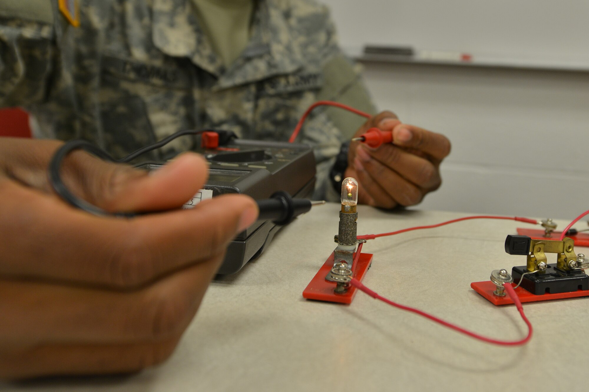 U.S. Army Reserve Pvt. Joshua Thomas, a railway operations student with the Maritime Intermodal Training Department, practices electrical techniques during the railway operations course at Fort Eustis, Va., Oct. 16, 2015. Throughout the four-week course, students learned an overview of railway operations to enable them to advise and assess rail operations worldwide. (U.S. Air Force photo by Staff Sgt. Natasha Stannard)