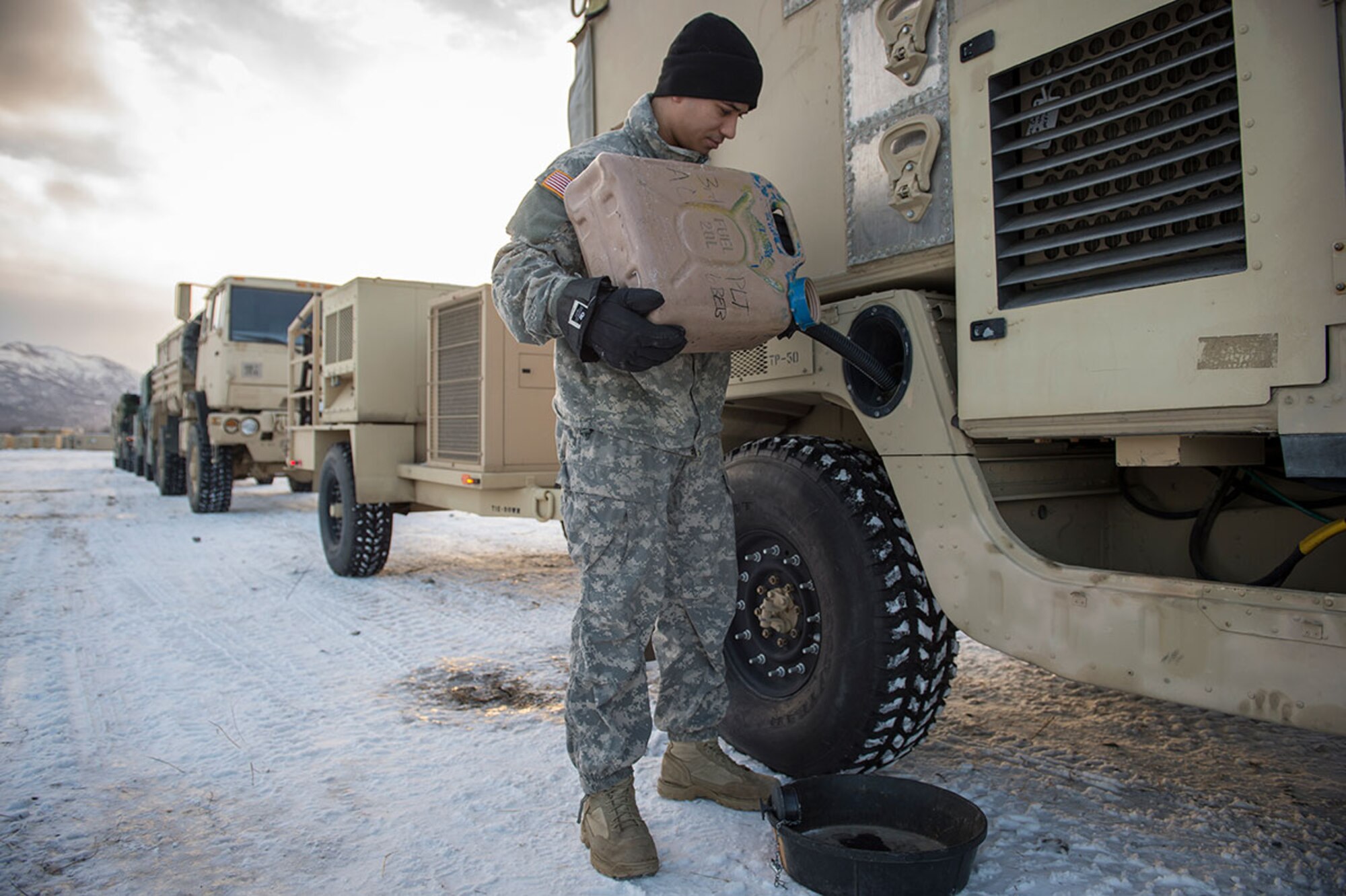 Soldiers assigned to the 4th Infantry Brigade Combat Team (Airborne), 25th Infantry Division, U.S. Army Alaska, prepare vehicles for a convoy to the port of Anchorage, Thursday, Dec. 17, 2015, for transport to the Joint Readiness Training Center at Fort Polk, La., where the brigade will conduct training.  (U.S. Air Force photo/Justin Connaher)