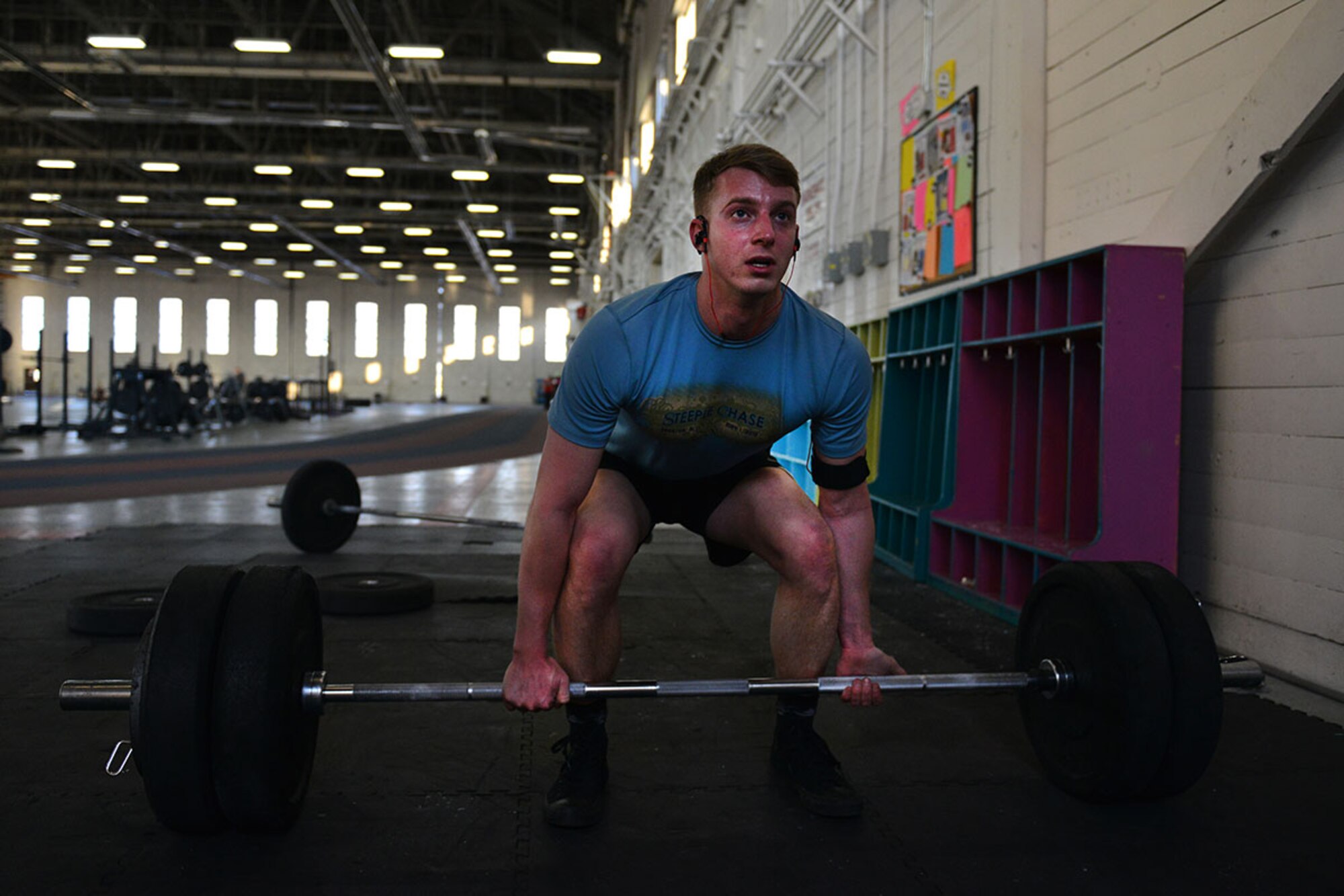 U.S. Army 1st Lt. John Bolding a platoon leader with C Company,1st Battalion (Airborne), 501st Infantry Regiment starts a deadlift in Hangar 5 December 31. As the new year comes, many will find the different fitness locations around JBER to be more trafficked, for information on what fitness centers are available, consult the front desk at either Buckner Physical Fitness Center, or Elmendorf Physical Fitness Center. (U.S. Air Force photo by Airman 1st Class Kyle Johnson)