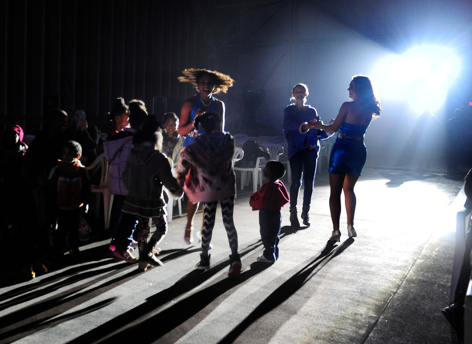 Tops in Blue vocalists dance with audience members during the 2015, “Freedom’s Song” world tour performance Jan. 6, 2016, at Incirlik Air Base, Turkey. Tops in Blue is the Air Force’s premier entertainment group stationed out of Joint Base San Antonio - Lackland AFB, Tx. (U.S. Air Force photo by Senior Airman Krystal Ardrey)