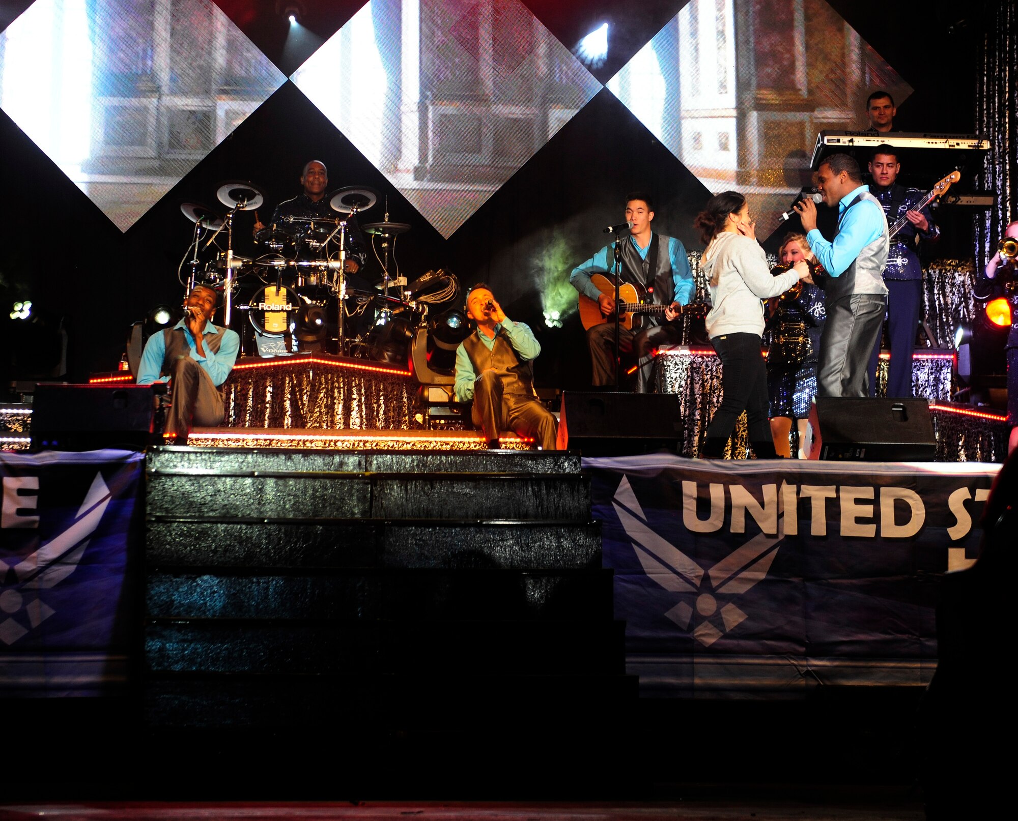 Tops in Blue members sing to an audience member during a performance on the 2015, “Freedom’s Song” world tour, Jan. 6, 2016, at Incirlik Air Base, Turkey. Tops in Blue visited Incirlik AB as part of their seven-month tour, which includes 75 shows in 20 different countries.  (U.S. Air Force photo by Senior Airman Krystal Ardrey)