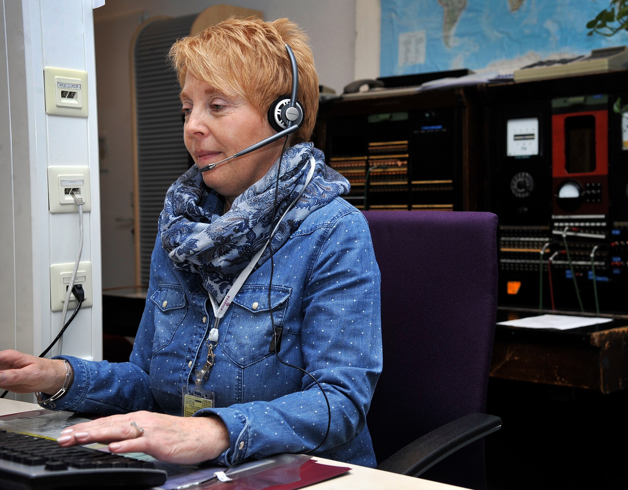 Christel Piscione, 86th Communications Squadron consolidated switchboard operator, answers and connects a call Jan. 4, 2016, at Ramstein Air Base, Germany. Piscione speaks English, German, Italian and a little French, which helps her assist people of different nationalities. (U.S. Air Force photo/Airman 1st Class Larissa Greatwood) 
