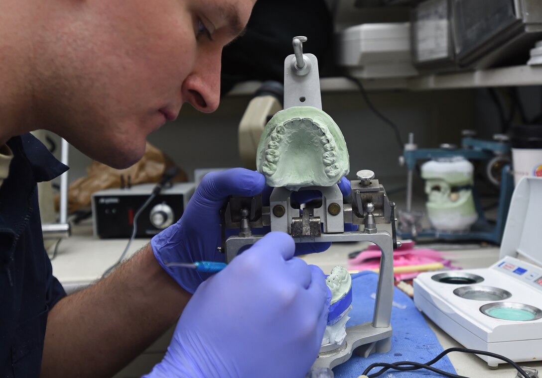 Staff Sgt. Kevin Styczynski, 779th Dental Squadron dental lab technician, works on a denture mold at Joint Base Andrews, Md., Jan. 7, 2016. Members of the 779th Medical Group strive to provide a full range of primary care services, medical and surgical sub-specialties to better serve military beneficiaries.  (U.S. Air Force photo/ Senior Airman Nesha Humes)