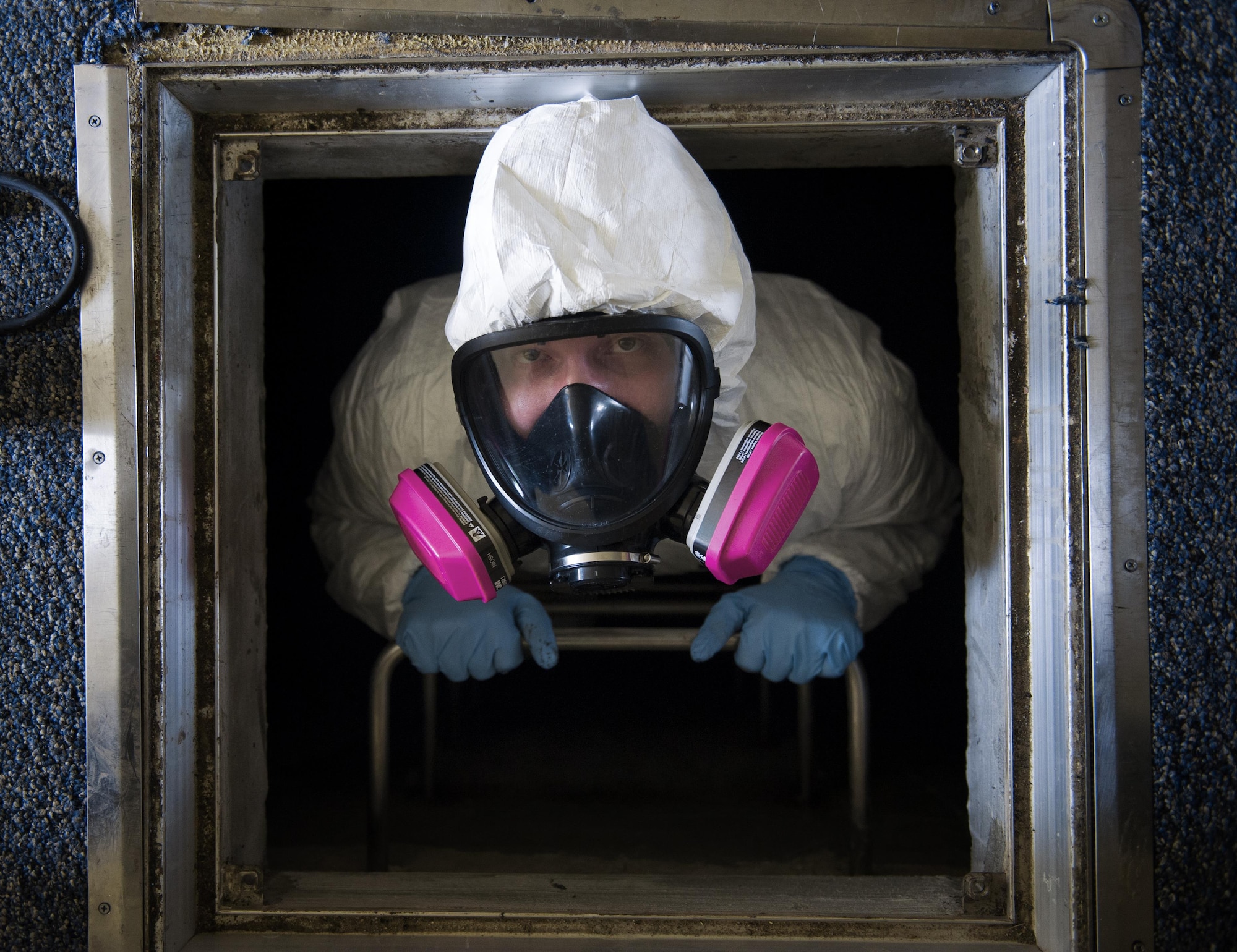 Staff Sgt. Brandon Cenarrusa, 374th Civil Engineer Squadron pest management craftsman, climbs out of the crawlspace of the Child Development Center at Yokota Air Base, Japan, Jan. 6, 2016. From performing disease vector surveillance to providing base wide pest control services for insects and wildlife, entomology Airmen utilize both preventative and immediate response maintenance practices to ensure that facilities remain pest free. (U.S. Air Force photo by Airman 1st Class Delano Scott/Released)