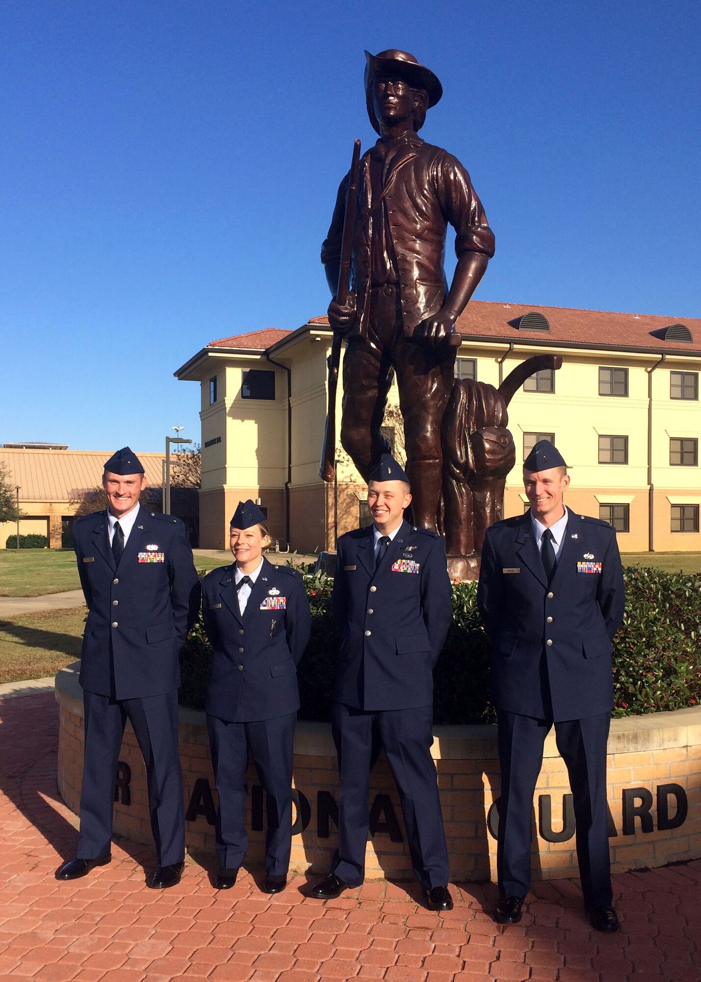 120th Airlift Wing 2nd Lieutenants Matthew Hall, Alissa Engel, Bradford Lewis, and Joshua Briggs pose at the statue to the Air National Guard minuteman located on the campus of the Officer Training School at Maxwell Air Force Base, Ala. Dec. 18, 2015. (U.S. Air National Guard photo by Capt. Kenneth Fechter/Released)