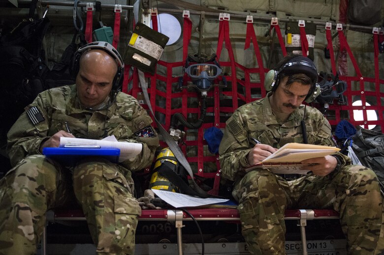 U.S. Air Force Airmen from the 379th Expeditionary Aeromedical Evacuation Squadron fill out medical forms for injured Airmen in support of Operation Inherent Resolve, Jan. 6, 2016, while flying over Southwest Asia. OIR is the coalition intervention against the Islamic State of Iraq and the Levant. (U.S. Air Force photo by Tech. Sgt. Nathan Lipscomb)