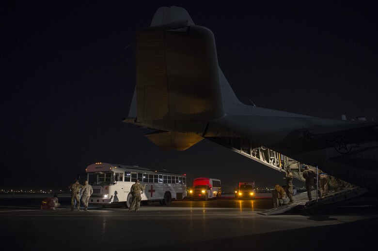 U.S. Air Force Airmen from the 379th Expeditionary Aeromedical Evacuation Squadron unload medical patients from a C-130H Hercules at Al Udeid Air Base, Qatar, in support of Operation Inherent Resolve, Jan. 6, 2016. OIR is the coalition intervention against the Islamic State of Iraq and the Levant. (U.S. Air Force photo by Tech. Sgt. Nathan Lipscomb)