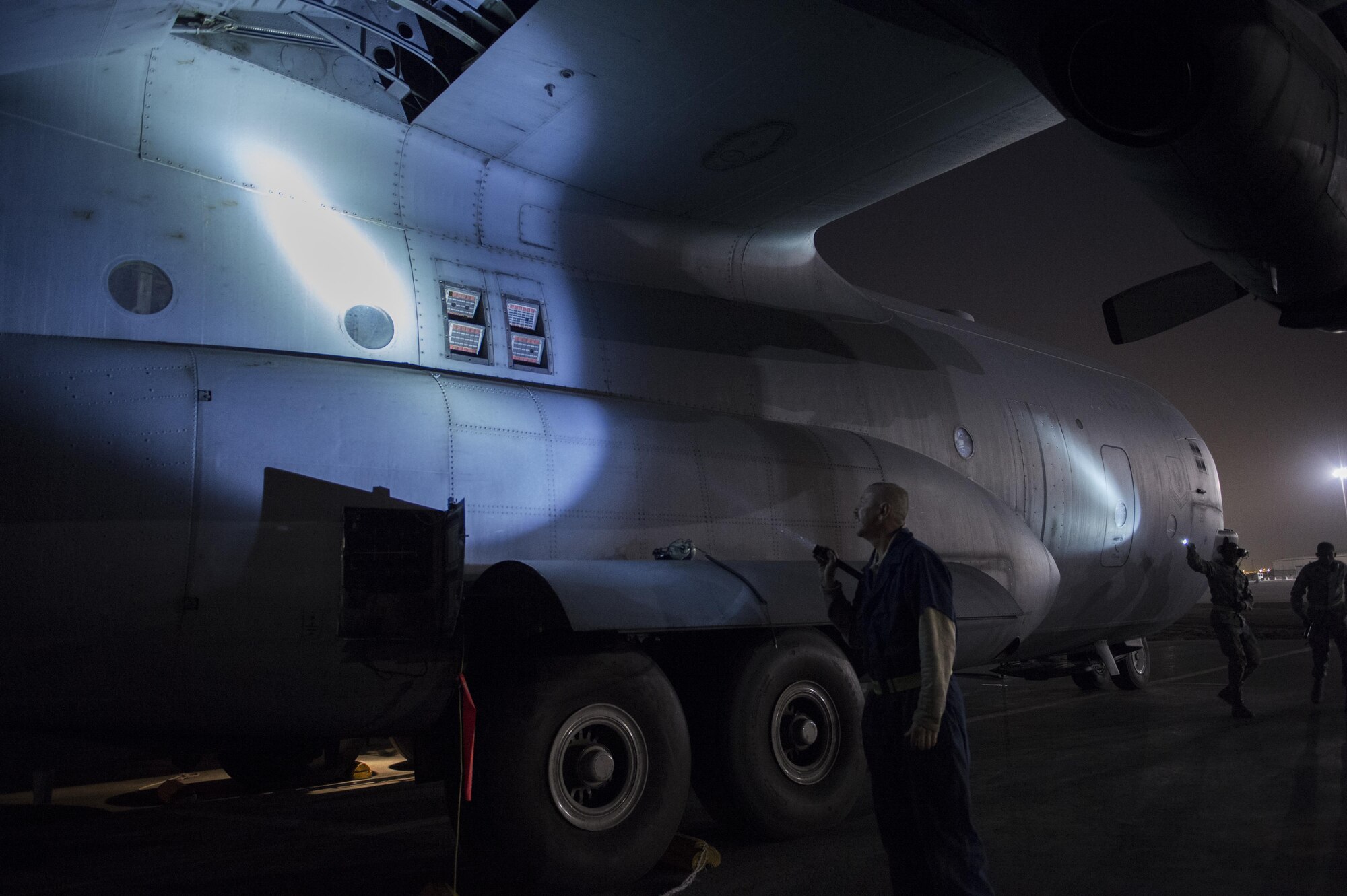 U.S. Air Force Airmen from the 746th Expeditionary Aircraft Maintenance Squadron inspect a C-130H Hercules at Al Udeid Air Base, Qatar, in support of Operation Inherent Resolve, Jan. 6, 2016. OIR is the coalition intervention against the Islamic State of Iraq and the Levant. (U.S. Air Force photo by Tech. Sgt. Nathan Lipscomb)