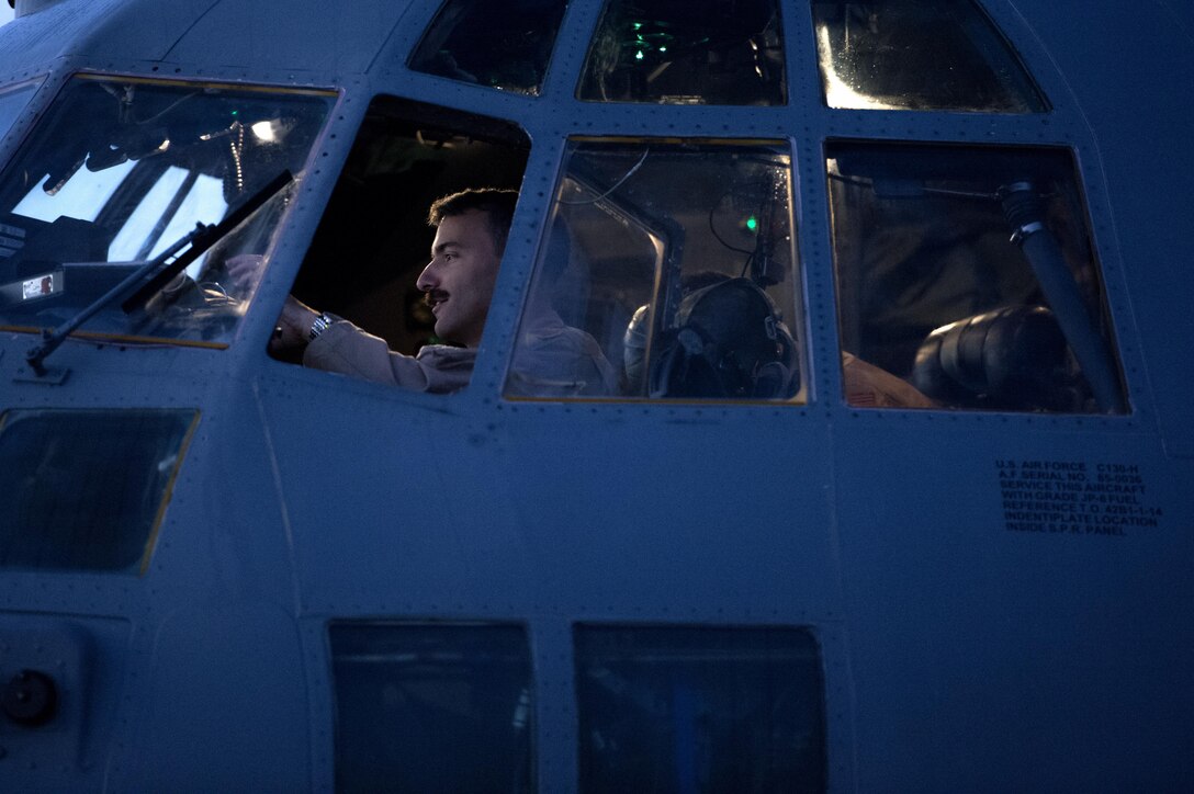 U.S. Air Force Capt. Steven Marinos, 746th Expeditionary Airlift Squadron pilot, perform preflight checks at Al Udeid Air Base, Qatar in support of Operation Inherent Resolve, Jan. 6, 2016. OIR is the coalition intervention against the Islamic State of Iraq and the Levant. (U.S. Air Force photo by Tech. Sgt. Nathan Lipscomb)