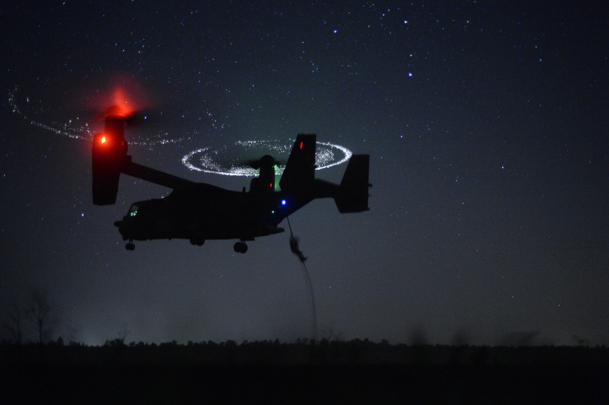 Combat controllers from the 21st Special Tactics Squadron fast-rope from a CV-22 Osprey during Emerald Warrior near Hurlburt Field, Fla., April 21, 2015. Emerald Warrior is the Defense Department's only irregular warfare exercise, allowing joint and combined partners to train together and prepare for real-world contingency operations. (U.S. Air Force photo/Staff Sgt. Jonathan Snyder)