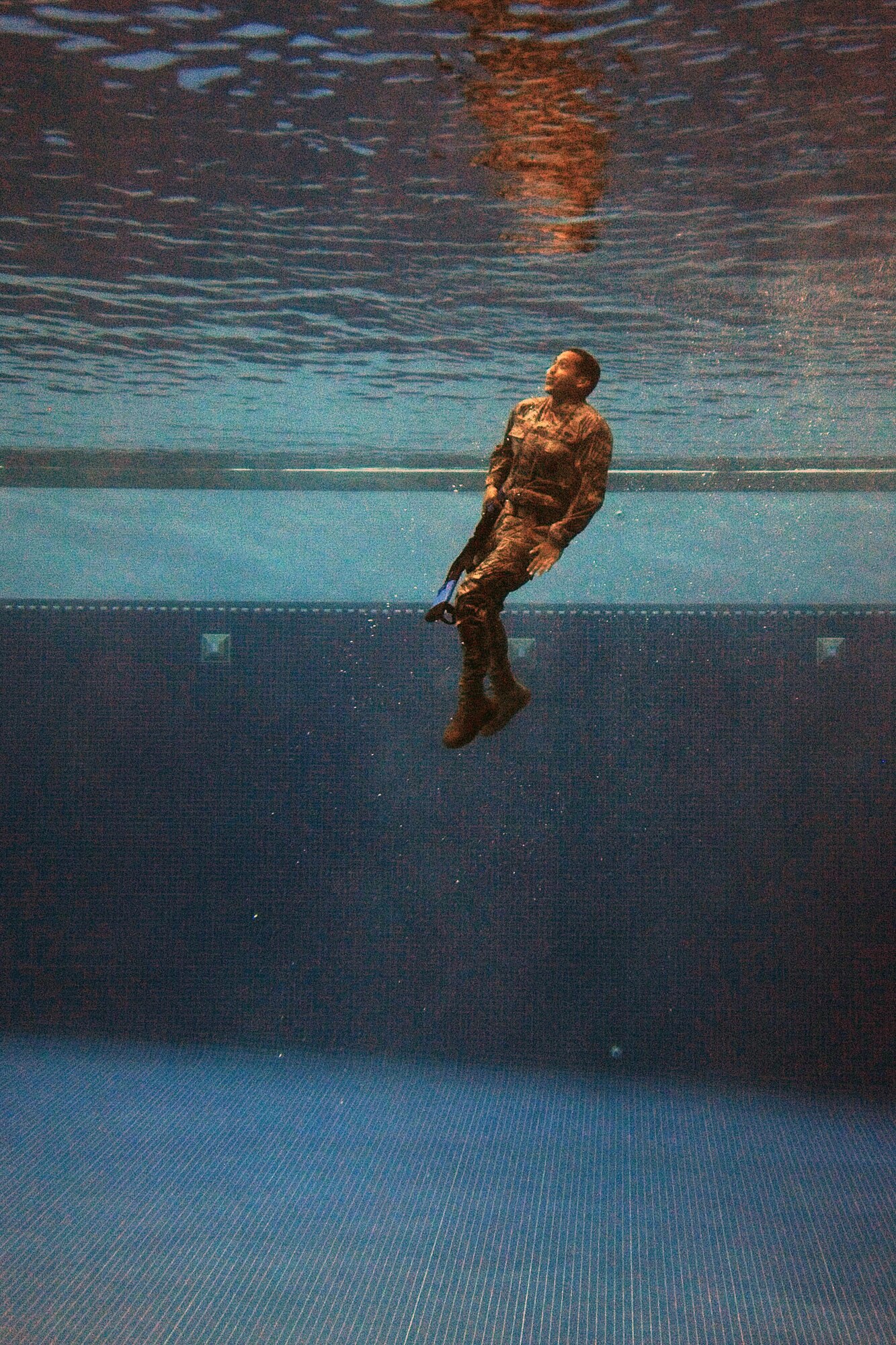 A security forces Airman plunges into the combat water survival test at the U.S. Air Force Academy, Colo., July 17, 2015. The event was part of a daylong course for Airmen across the Front Range area to determine if they are physically and mentally ready to attend the U.S. Army Pre-Ranger Training Assessment Course, a prerequisite to attending the U.S. Army Ranger School at Fort Benning, Ga. (U.S. Air Force photo/Jason Gutierrez)