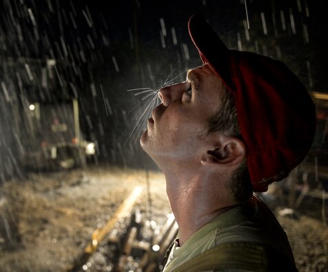 Staff Sgt. Fred Frizzell, an 823rd Expeditionary RED HORSE Squadron pavements and construction equipment operator, works a drilling rig at a well site in Brisas del Mar, Honduras, July 30, 2015. Frizzell monitored the drilling rig during the development phase of the well site -- a process that involved blowing high-pressure air through the screens at the bottom of the well, removing any excess sediment buildup around the screens. This was the second well site constructed during humanitarian exercise New Horizons Honduras 2015. (U.S. Air Force photo/Capt. David J. Murphy)