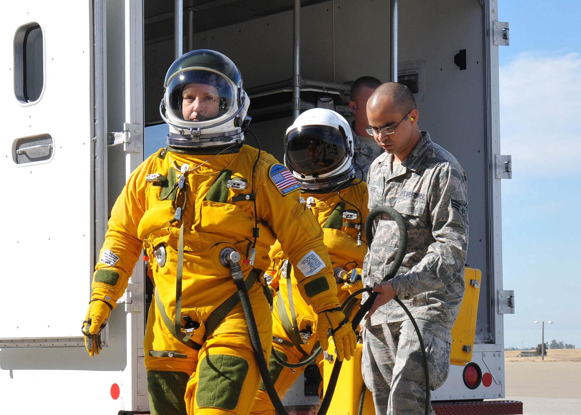 Secretary of the Air Force Deborah Lee James walks to a U-2S as Senior Airman Aaron Saenz, a 9th Physiological Support Squadron launch and recovery technician, carries the high-altitude pressure suit auxiliary equipment at Beale Air Force Base, Calif., Aug. 11, 2015. The specialized pressure suit allows U-2S pilots to safely fly at altitudes reaching 70,000 feet. James visited Beale AFB to receive a firsthand perspective of high-altitude intelligence, surveillance and reconnaissance from collection to dissemination. (U.S. Air Force photo/Senior Airman Dana J. Cable)