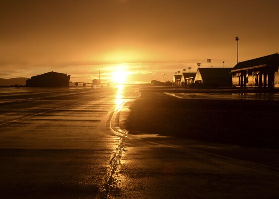 The sun shines along the horizon as an aircraft taxies down a flightline during Global Thunder 2016, an exercise that took place Nov. 2-8, 2015, to test the readiness of air refueling wings at McConnell Air Force Base, Kan. (U.S. Air Force photo/2nd Lt. Krystal Jimenez)
